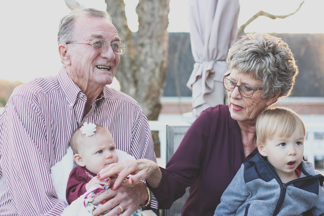 Grandparents holding 2 children